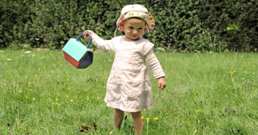 toddler girl in a dress playing outside